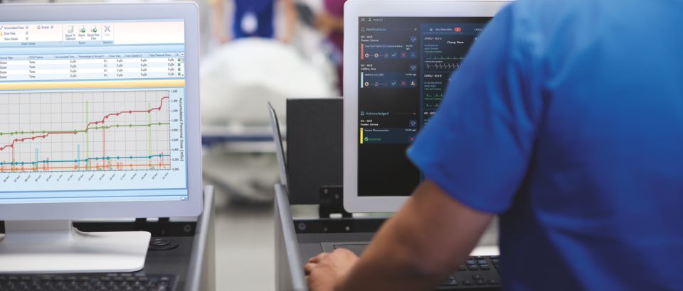 Medical professionals viewing info on screen