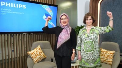 Özlem Fidanci and Astri R. Dharmawan raise fists for women's empowerment