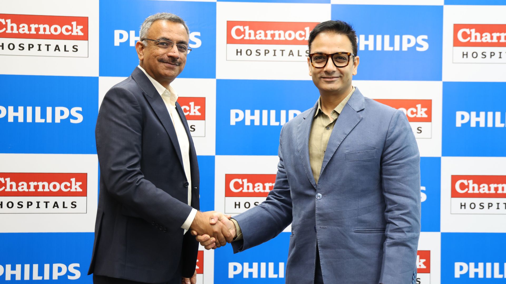 Bharath Sesha and Prashant Sharma shaking hands