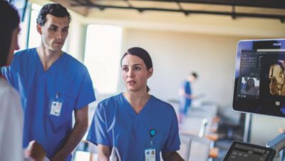Healthcare professionals discussing ultrasound results on Philips system