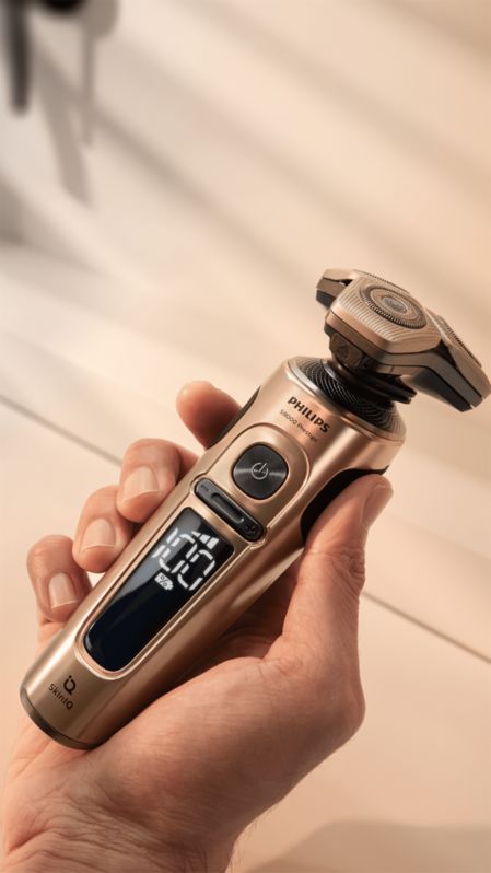 A hand holding an electric shaver
