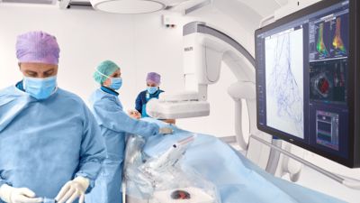 Interventional physicians performing a procedure on a patient