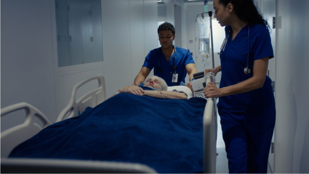 The patient lays on a hospital stretcher as she is monitored by the Philips IntelliVue X3 and Philips validated supplies. 