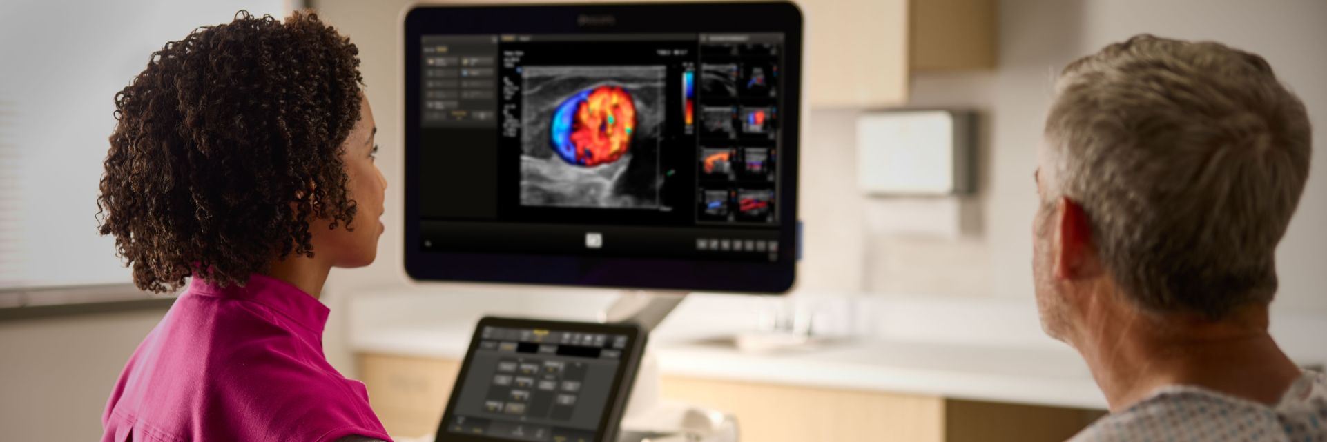 A sonographer performing a musculoskeletal ultrasound exam focused on a patient’s arm