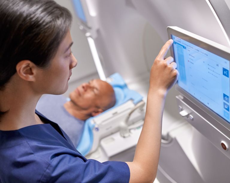 Technologist adjusting settings on MRI VitalScreen