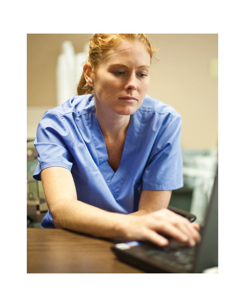 clinician working at laptop