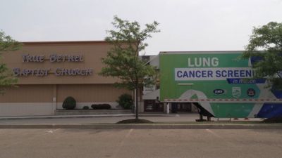 Mobile lung cancer screening unit parked outside church