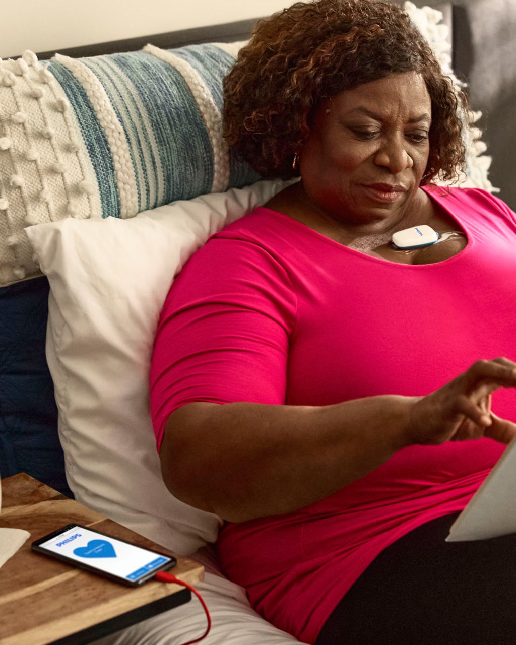 Patient wearing MCOT patch at home in bed