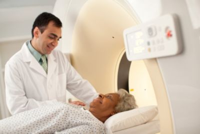 Physician senior patient on table CT