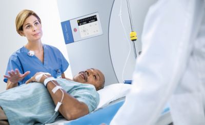 Doctor helping patient with spectral CT scan