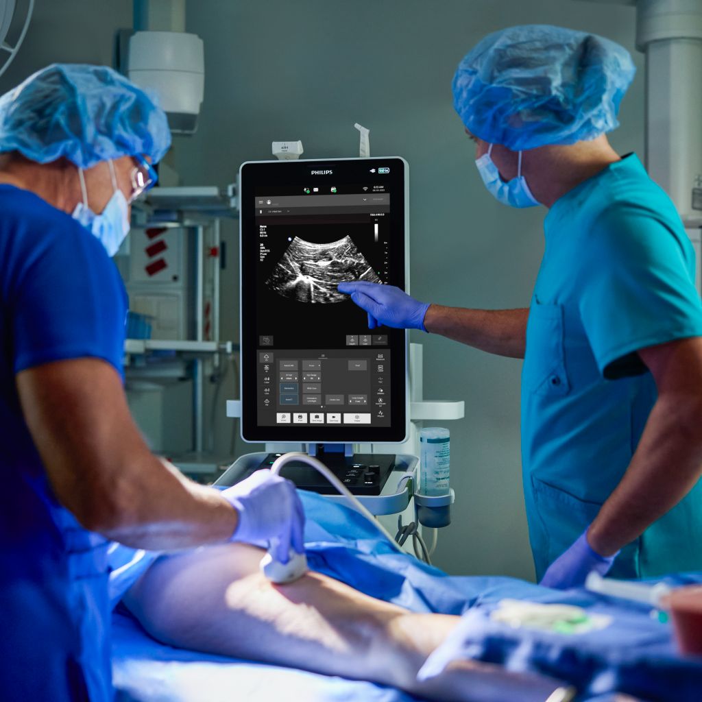 Two clinicians in anesthesia care setting utilizing mobile ultrasound system 