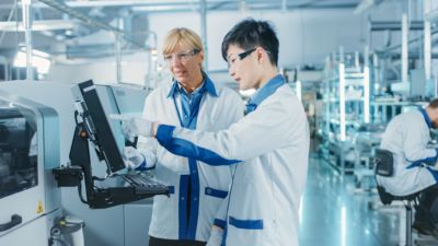 Two scientists analyzing data on a computer system in a laboratory