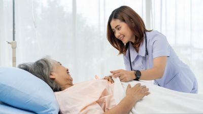 Nurse providing compassionate care to patient in hospital bed