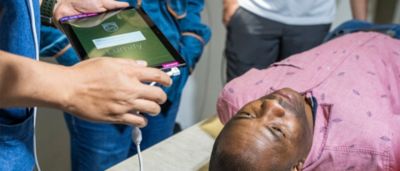 Clinician using Philips Lumify portable ultrasound on patient in point of care setting