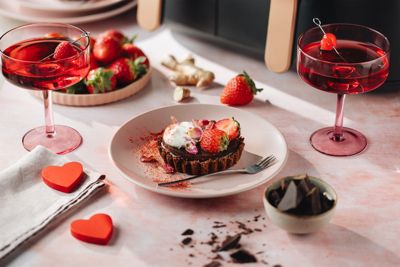 Dark chocolate tart served with strawberries and cream