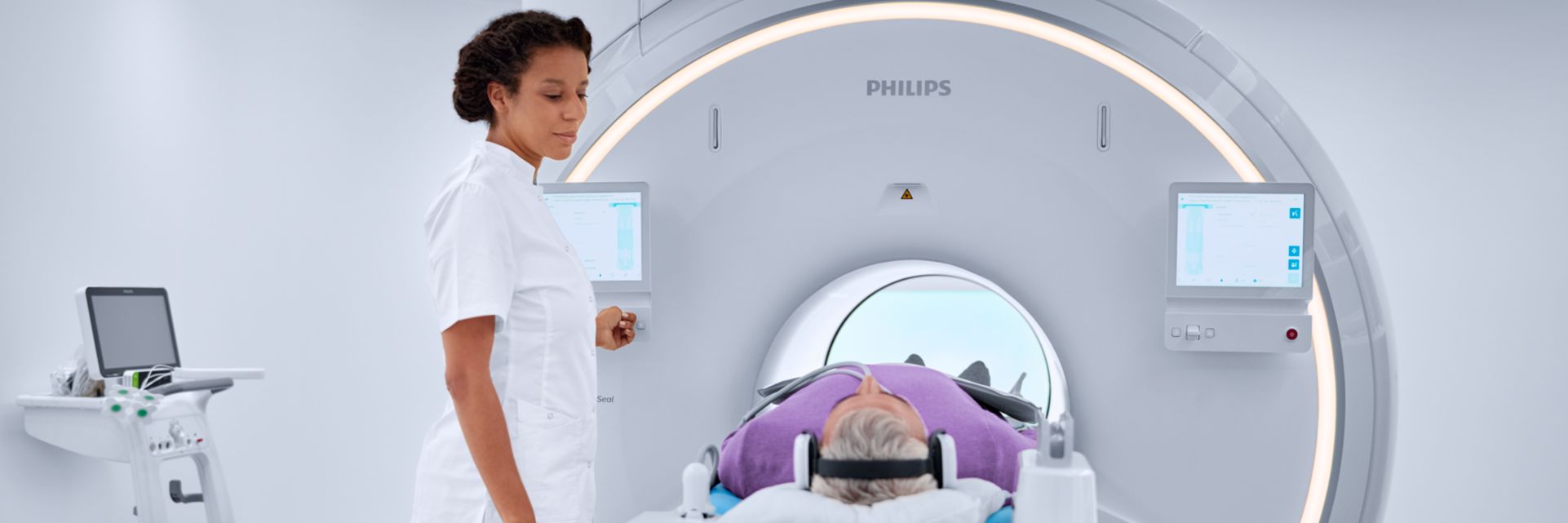 technologist moves patient into the bore of the mri