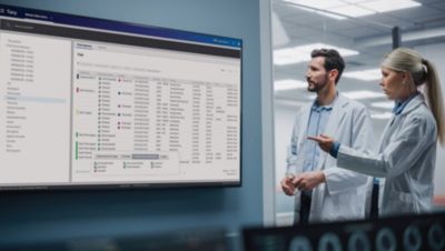 Clinicians reviewing patient data and workflow information on Philips Tasy screen in clinical setting