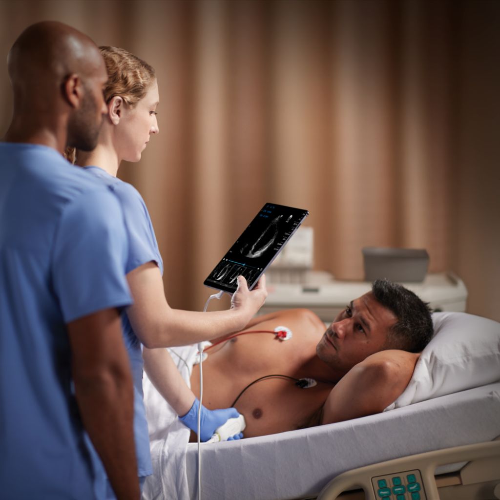 Clinician performing cardiac ultrasound scan of critical care patient