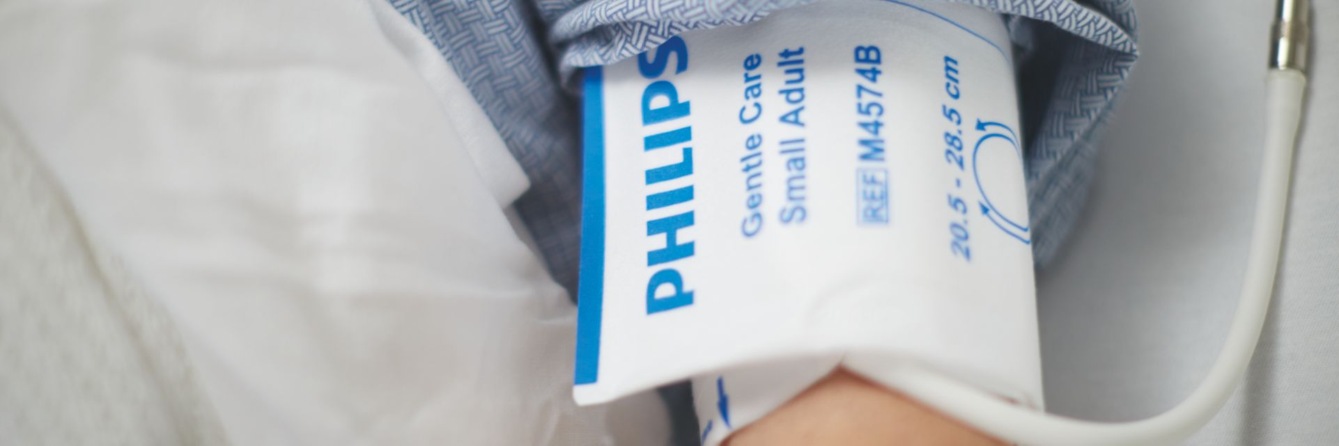 Image of a patient using a blood pressure cuff.