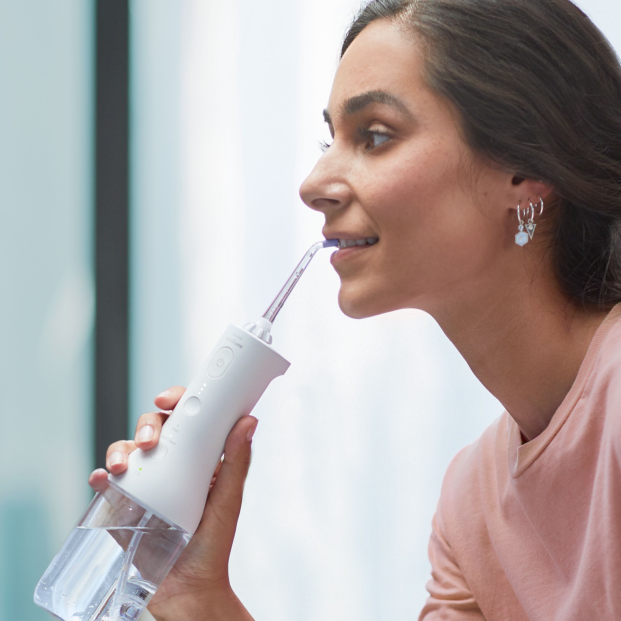 Woman using a Cordless Power Flosser