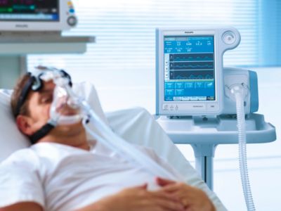 Patient receiving noninvasive respiratory support with Philips Respironics V60 ventilator