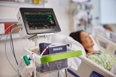 Patient monitor displaying vital signs at bedside in general care unit