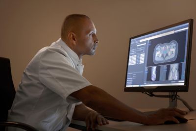 Radiology consultant reviewing diagnostic images on a Philips system in a hospital command center
