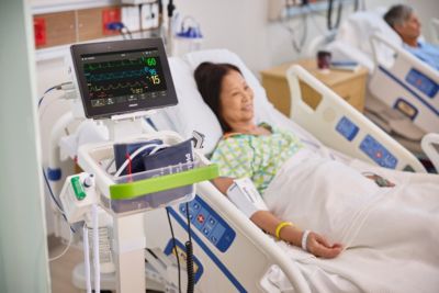 Patient in intensive care bed connected to Philips patient monitoring system