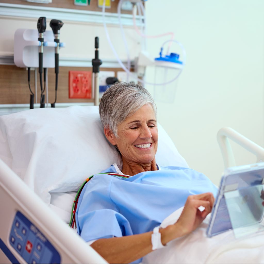 patient in bed using tablet