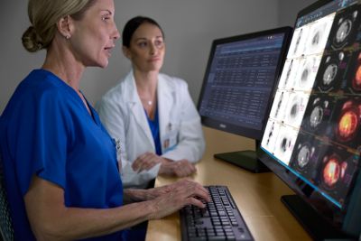 Radiologists checking patient data on a monitor