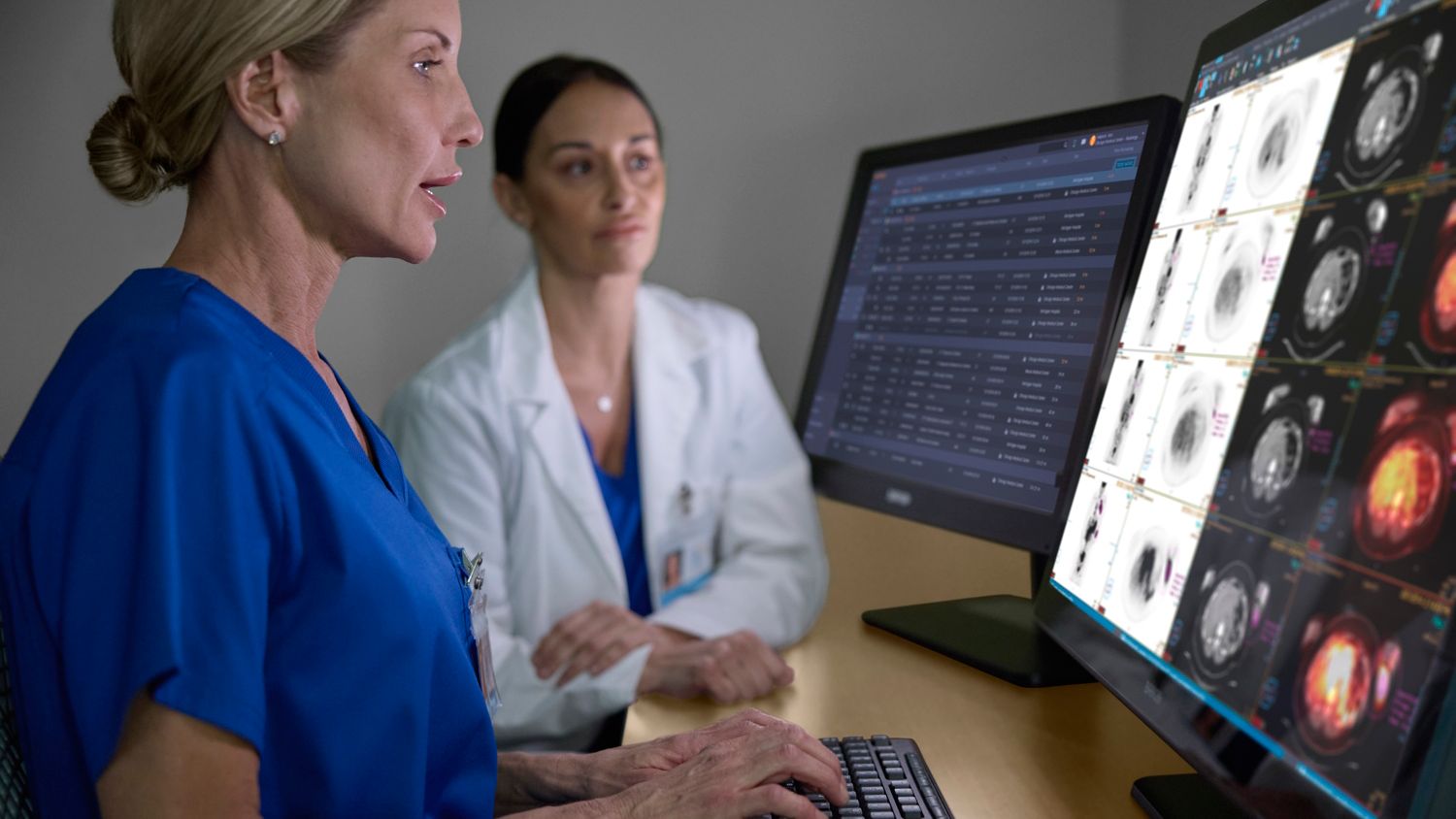 Radiologists checking patient data on a monitor
