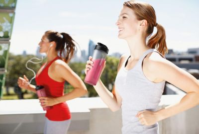 Two Women Jogging with Drink Bottles
