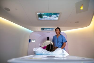 Patient undergoing scan using Philips Spectral CT 7500 system with technologist support