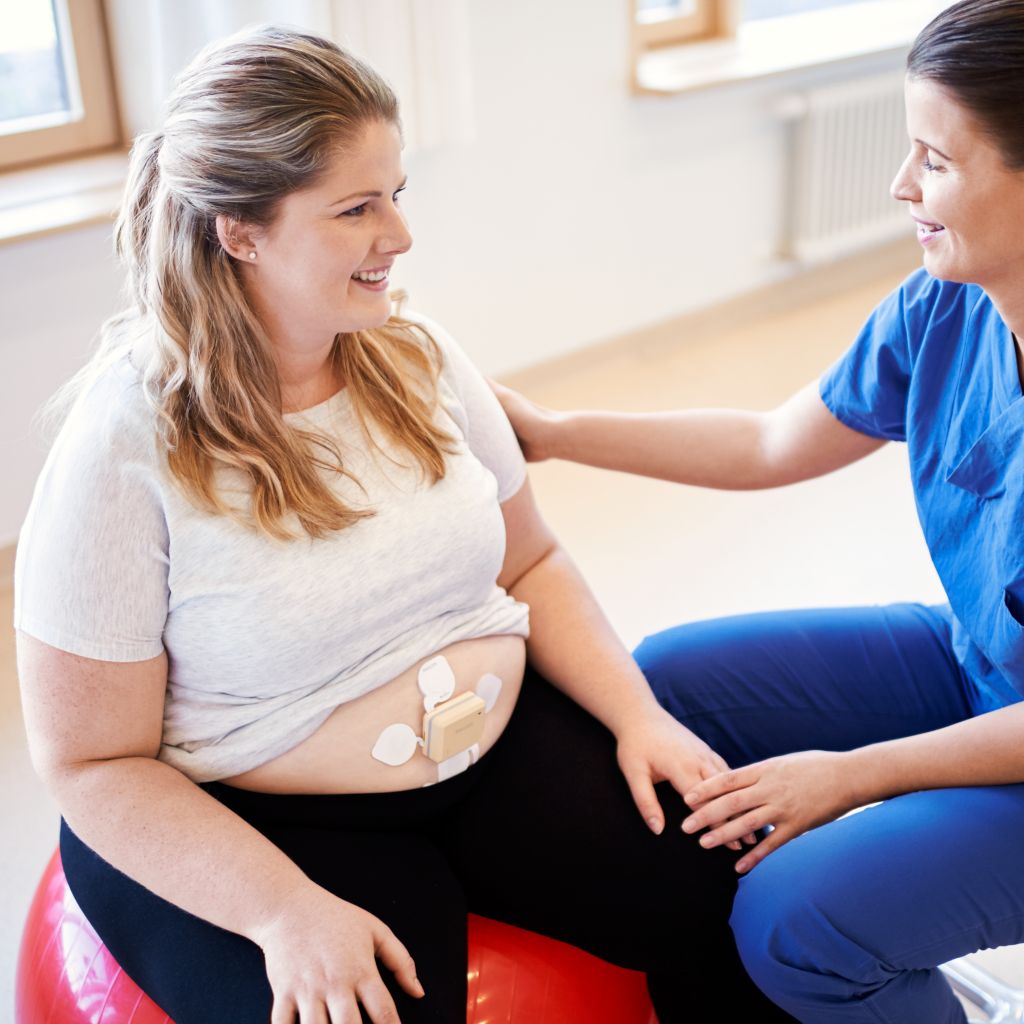 pregnant woman with beltless solution on a yoga ball