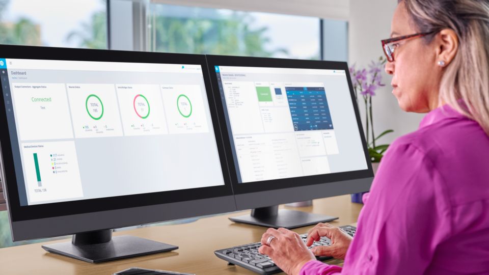 Female clinician reviewing MDIP Dashboard and Neuron CX