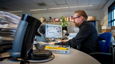 Mark Olof Dirksen working at computer analyzing product design materials