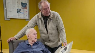 Hugo and Dirk Vananderoye reviewing historic Philips product design sketches
