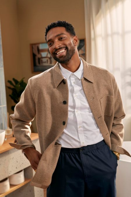 Man smiling in mirror with freshly trimmed beard