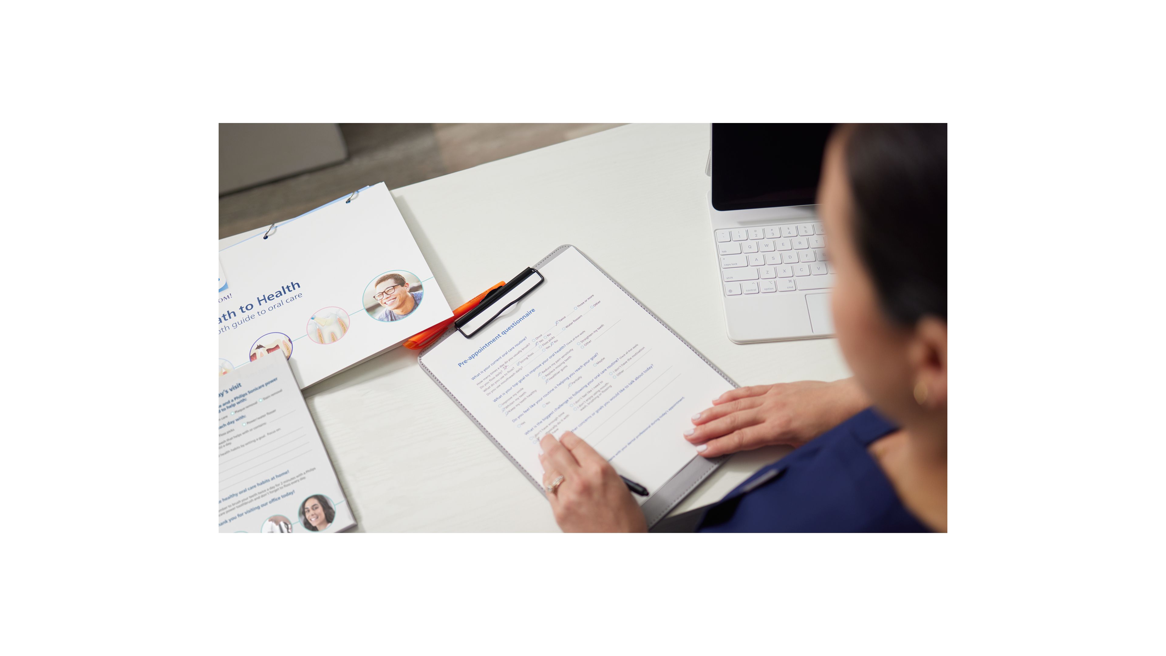 Hands holding a collection of educational brochures