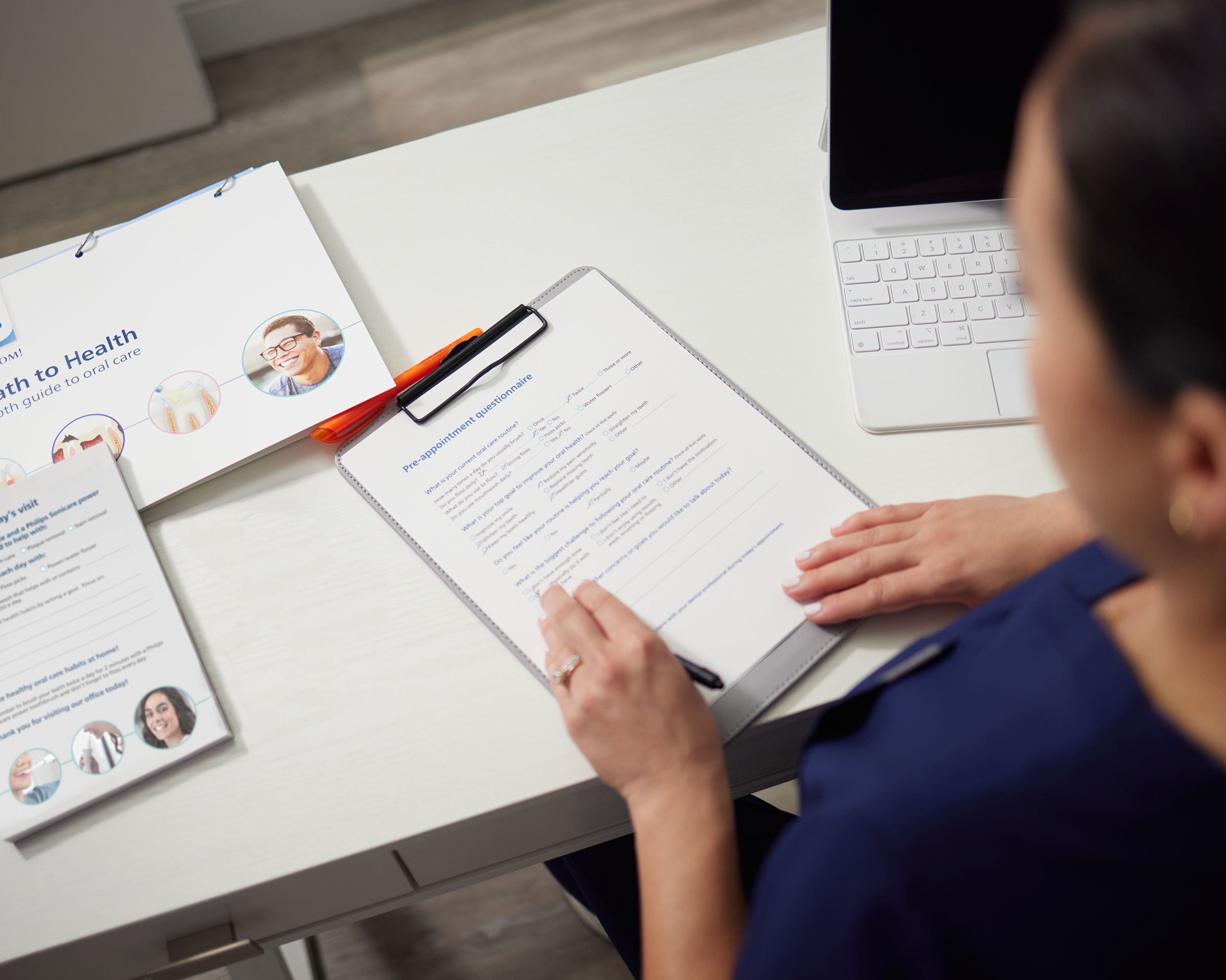 A dental professional looking at the Path to Health toolkit items