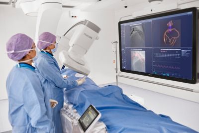Cath lab team reviewing CT and X ray images during PCI procedure