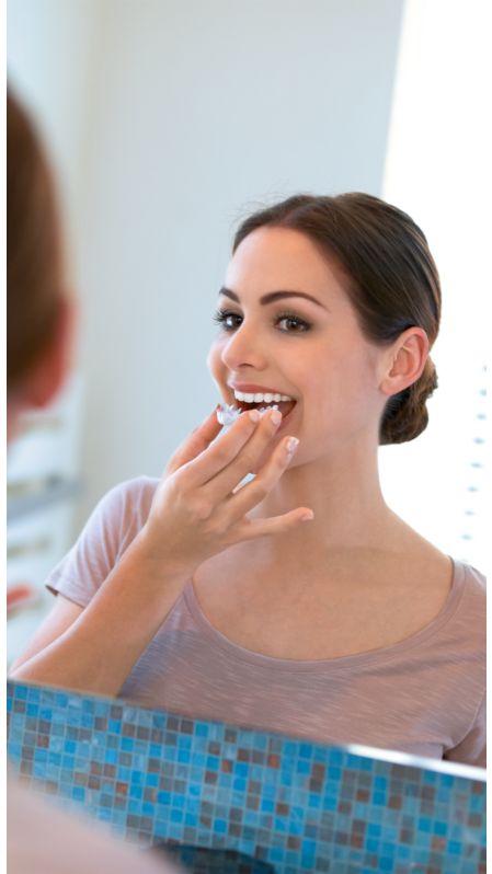 Woman placing a Phlips Zoom! take-home whitening tray