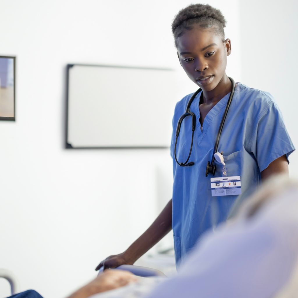 Healthcare profession and patient lies in bed