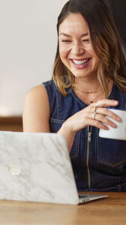 Woman using a laptop and smiling