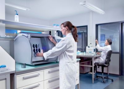 Laboratory technician working with automated diagnostic equipment