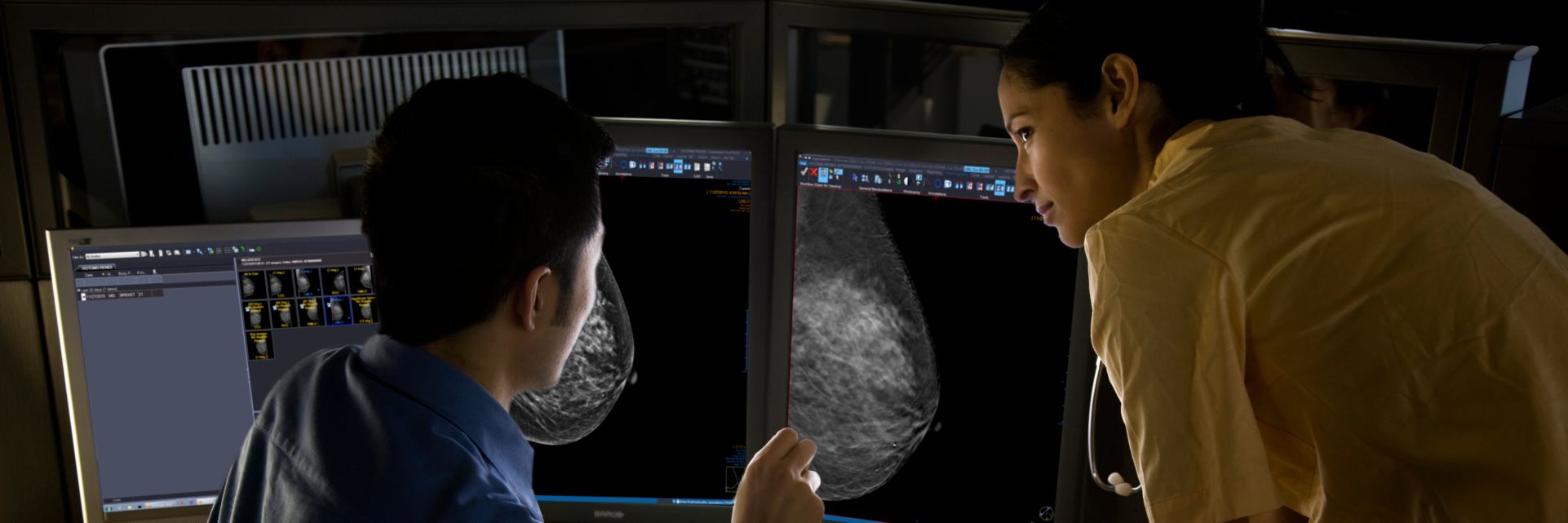 Radiologist in a dark room performing a Mammo Reporting