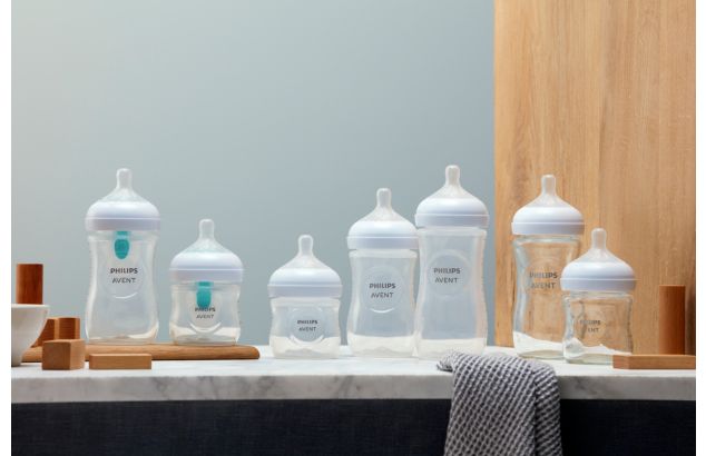 Different Philips Avent baby bottles on display next to each other on a marble surface.