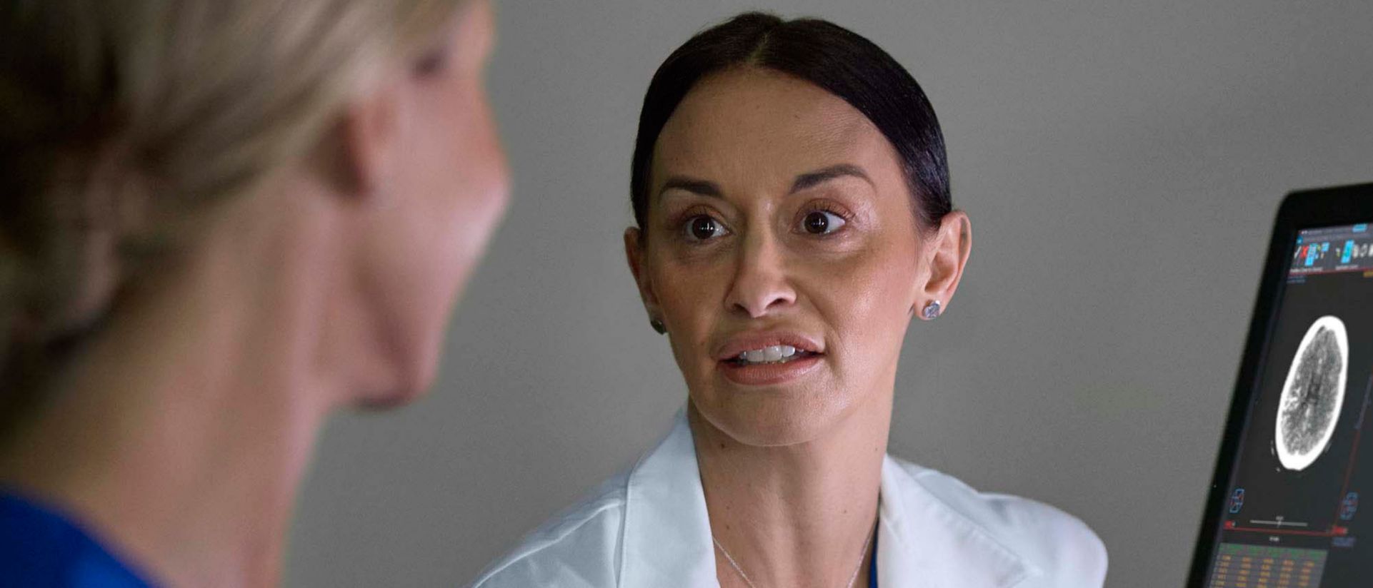 Nurses review patient data from eCareManager remote monitoring software on screens