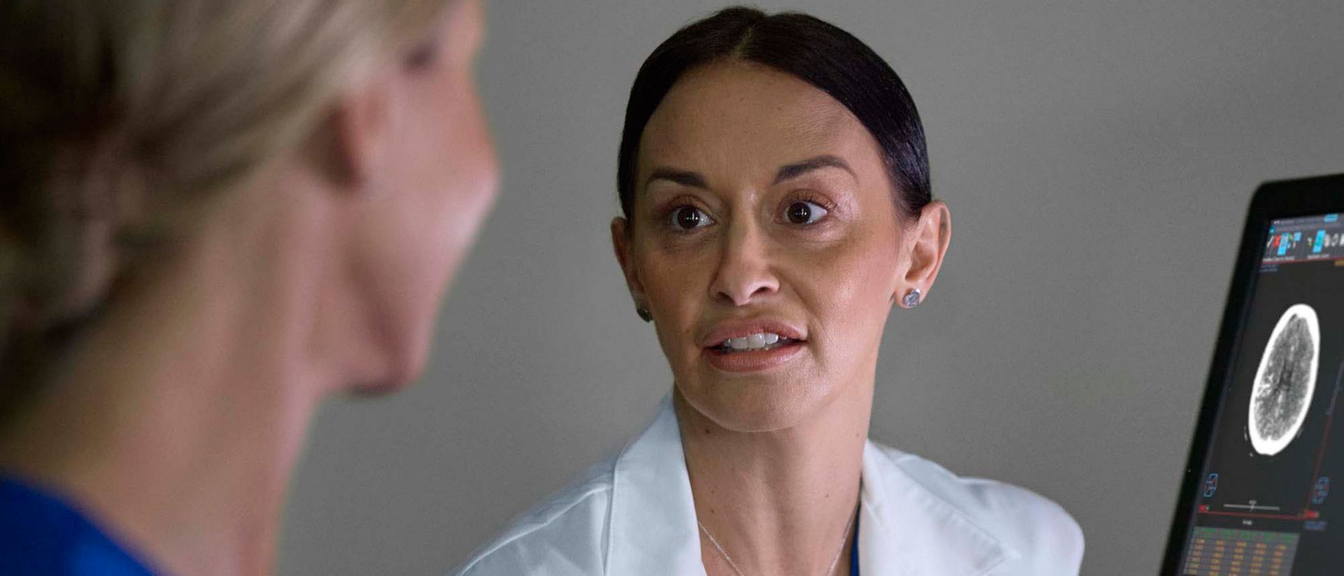 Nurses review patient data from eCareManager remote monitoring software on screens