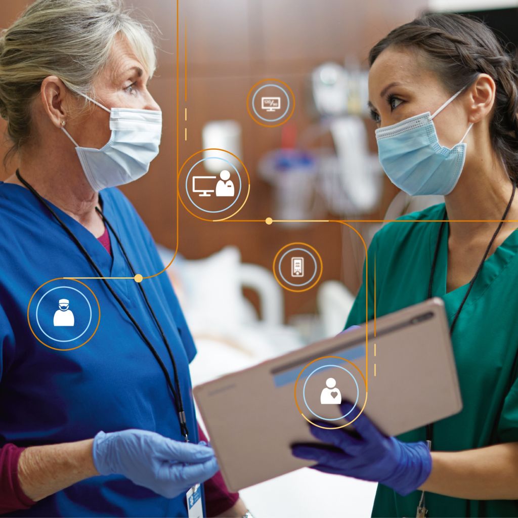 A clinician confers with a tablet 